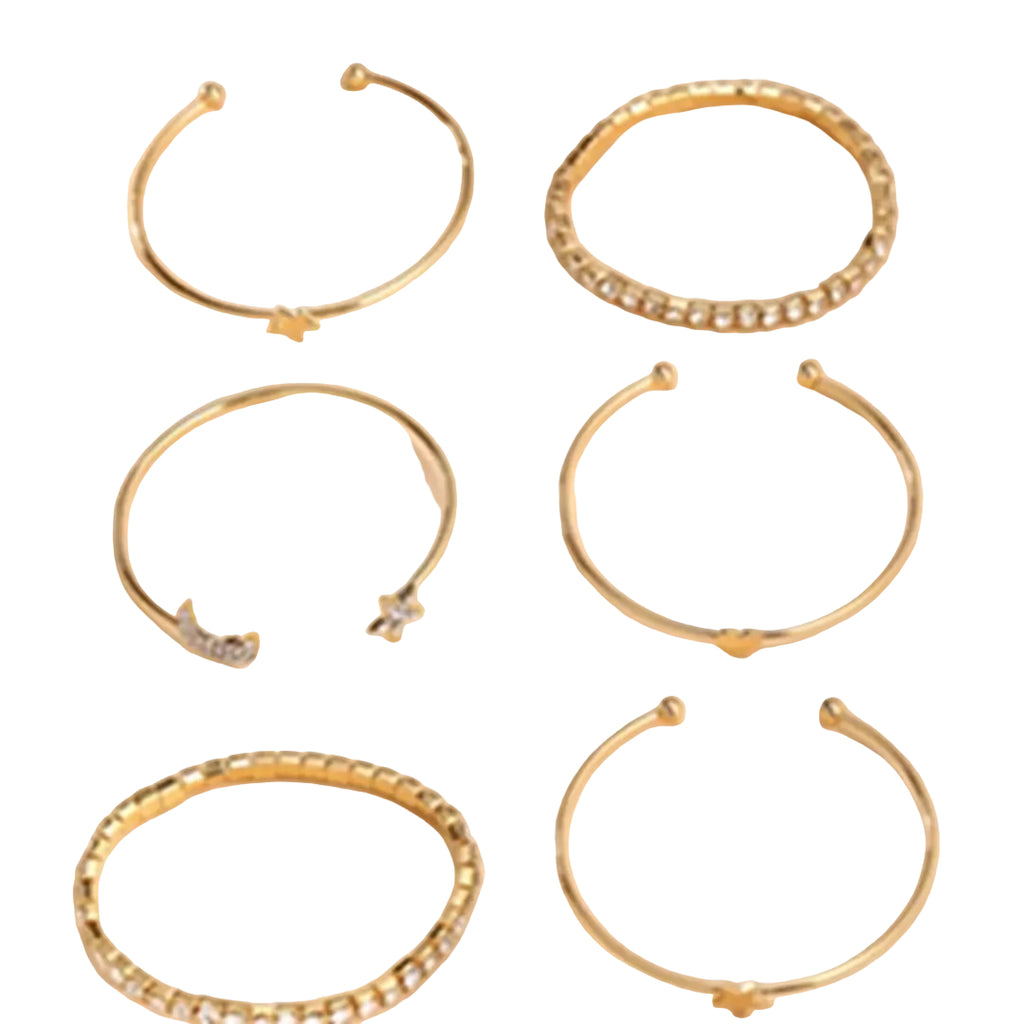 Set of gold hoop earrings on a beige background