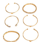 Set of gold hoop earrings on a beige background