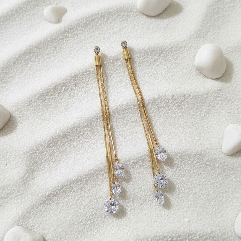 Dazzling CZ Dangle Chain Earrings - ORYX TREND EaringStep into the spotlight with these exquisite Dazzling CZ Dangle Chain Earrings. Featuring three cascading gold chains that end with brilliant, faceted Cubic Zirconia (CZ) stones, these long drop earrings add movement and sparkle to any look. The tassel design is lightweight and glamorous, perfect for weddings, parties, or special evenings. Style: Drop, Dangle, Tassel, Elegant, GlamourDefault Title#