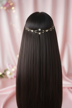 Long black hair with a decorative headband against a pink background