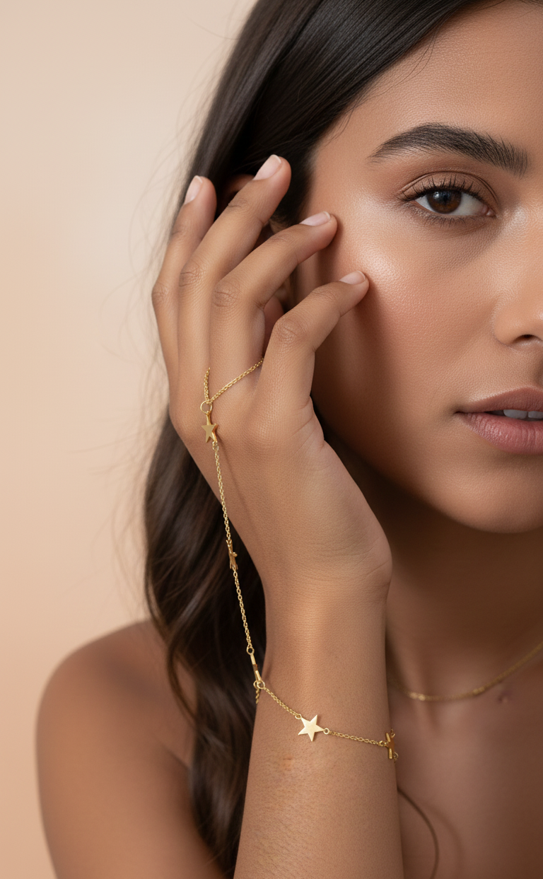 Woman wearing a gold bracelet with a star charm on a beige background