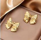 Chic Gold Bow Stud Earrings - ORYX TREND EaringThese charming gold bow stud earrings are a sweet and stylish accessory. Featuring a classic and elegant bow shape, they have a subtle, folded texture that adds a touch of dimension. Crafted from durable stainless steel, these earrings are perfect for everyday wear and sensitive ears. Their petite size and timeless design make them a delightful addition to any jewelry collection.Default Title#