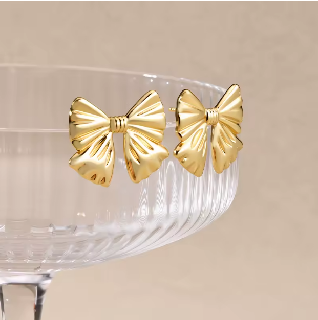 Chic Gold Bow Stud Earrings - ORYX TREND EaringThese charming gold bow stud earrings are a sweet and stylish accessory. Featuring a classic and elegant bow shape, they have a subtle, folded texture that adds a touch of dimension. Crafted from durable stainless steel, these earrings are perfect for everyday wear and sensitive ears. Their petite size and timeless design make them a delightful addition to any jewelry collection.Default Title#