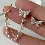 Crystal Butterfly and Pearl Chain Ear Cuff Set - ORYX TREND EaringDesign: Asymmetrical set featuring a pave crystal butterfly stud connected by a double chain of delicate faux pearls to a simple ear cuff.Default Title#