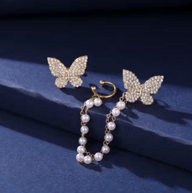 Crystal Butterfly and Pearl Chain Ear Cuff Set - ORYX TREND EaringDesign: Asymmetrical set featuring a pave crystal butterfly stud connected by a double chain of delicate faux pearls to a simple ear cuff.Default Title#