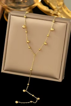 Gold necklace on a beige jewelry box with a blurred background