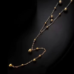 Gold and silver chain necklace on a dark background
