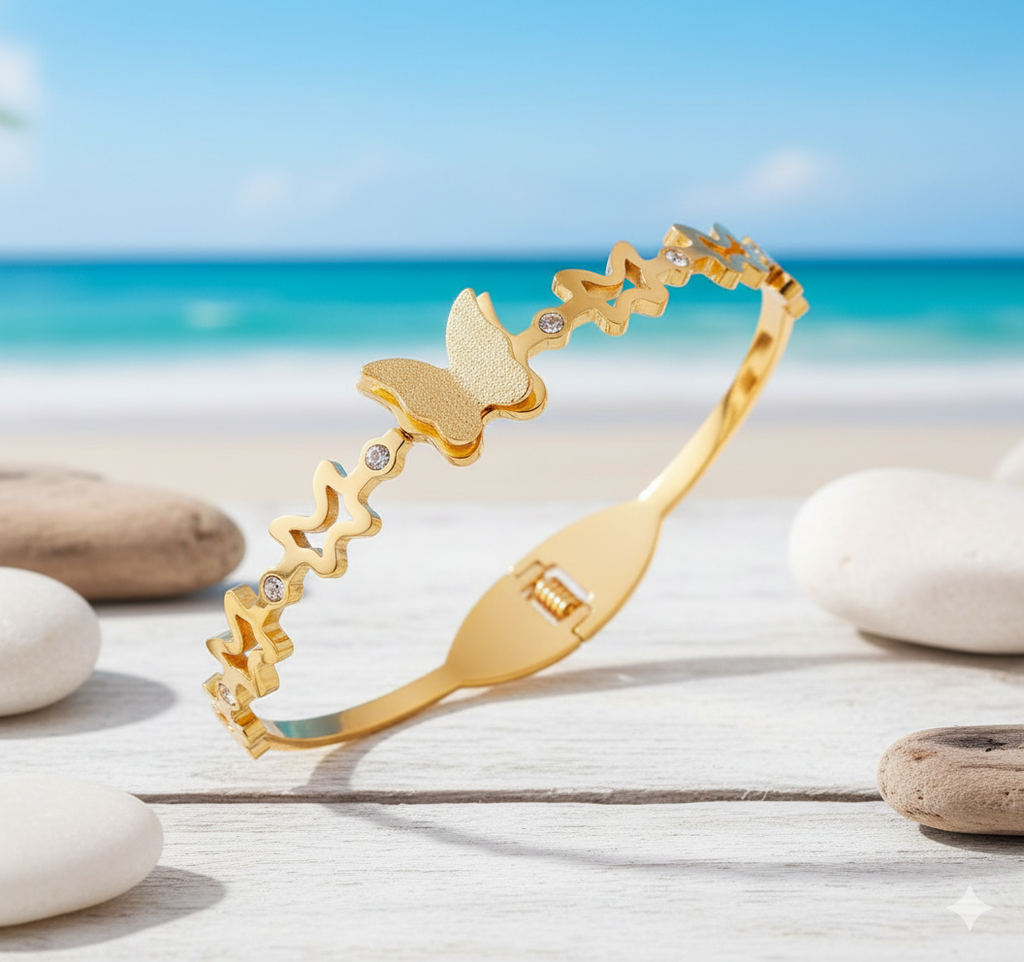 Dainty Gold Butterfly Cuff Bracelet with Crystal Accents - ORYX TREND BraceletsAn elegant gold-tone bangle bracelet featuring a central, intricately textured butterfly charm. The rest of the cuff is adorned with delicate cutout butterfly shapes, interspersed with small, sparkling crystal accents. This piece uses a durable, hinged clasp for secure and comfortable wear. It beautifully symbolizes transformation and grace, making it a perfect statement piece or a thoughtful gift.Default Title#