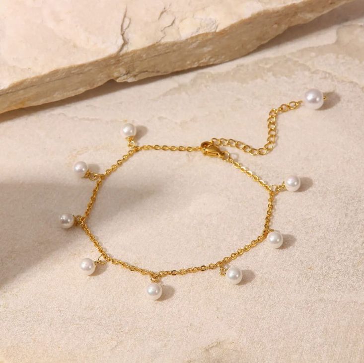 Dainty Pearl and Gold Anklet - ORYX TREND AnkletThis charming gold chain anklet is adorned with delicate, evenly spaced pearl beads, creating a classic and elegant look. The dainty design is perfect for adding a touch of sophistication to your summer style. With its adjustable chain, this pearl anklet offers a comfortable fit for any ankle, making it an ideal accessory for both casual and dressy occasions.Default Title#