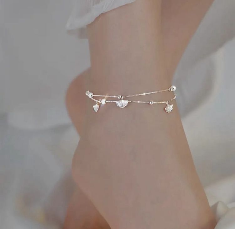 Dainty Silver Beaded Anklet with Ginkgo Charms - ORYX TREND AnkletAdorn your ankle with our minimalist ginkgo leaf charm anklet. The two-layered design includes a sleek chain and a beaded chain, each with tiny, intricate ginkgo leaves. This dainty and elegant piece is a stylish addition to your warm-weather jewelry collection.Default Title#