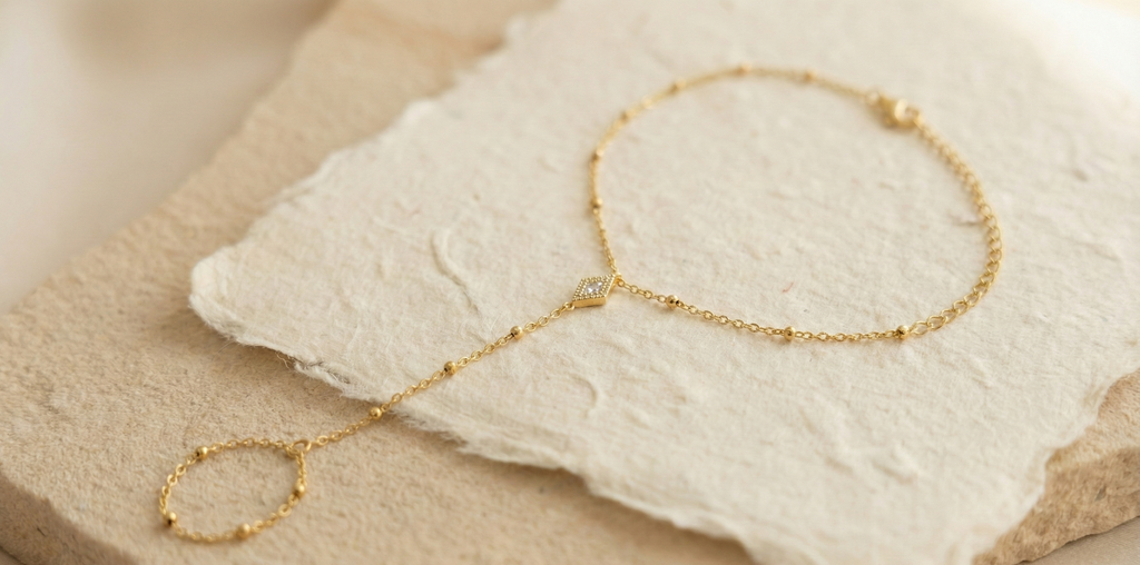 Diamond Shape Hand Harness Bracelet - ORYX TREND Hath PhoolThis delicate Hath Phool (Hand Flower) is a modern take on a classic piece of South Asian jewelry. Featuring a slim chain of polished gold beads connecting a single finger ring to an elegant bracelet, it's accented by a central diamond-shaped charm. This minimalist hand harness is perfect for bridesmaids, festivals, or adding a unique, elegant touch to everyday wear. Style: Hath Phool, Hand Harness, Minimalist, TraditionalDefault Title#