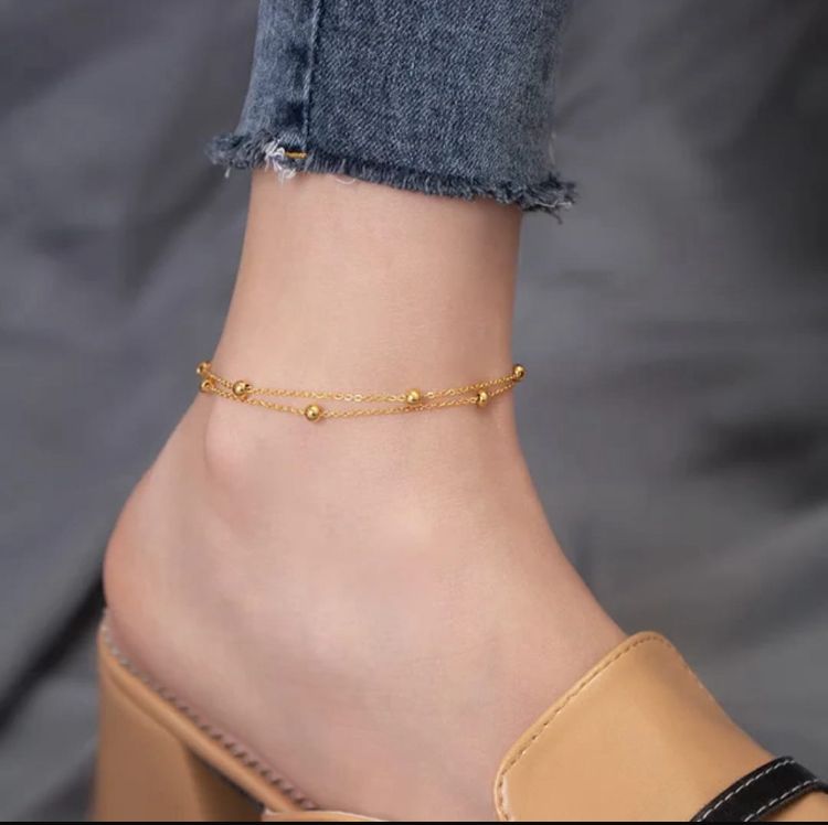 Double Layered Gold Beaded Anklet - ORYX TREND AnkletElevate your summer style with this elegant double-layered anklet. Featuring delicate gold chains adorned with polished ball beads, this minimalist ankle bracelet is the perfect accessory for adding a subtle touch of glamour to any outfit.Default Title#