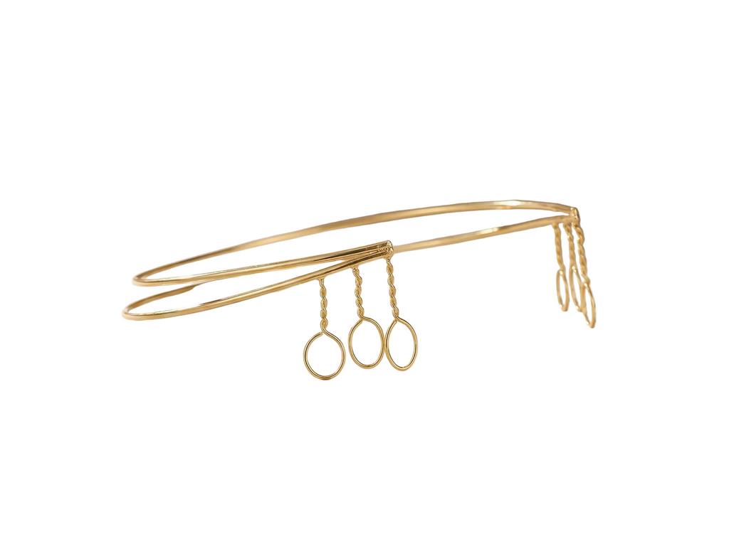 Gold headband with hair clips on a white background