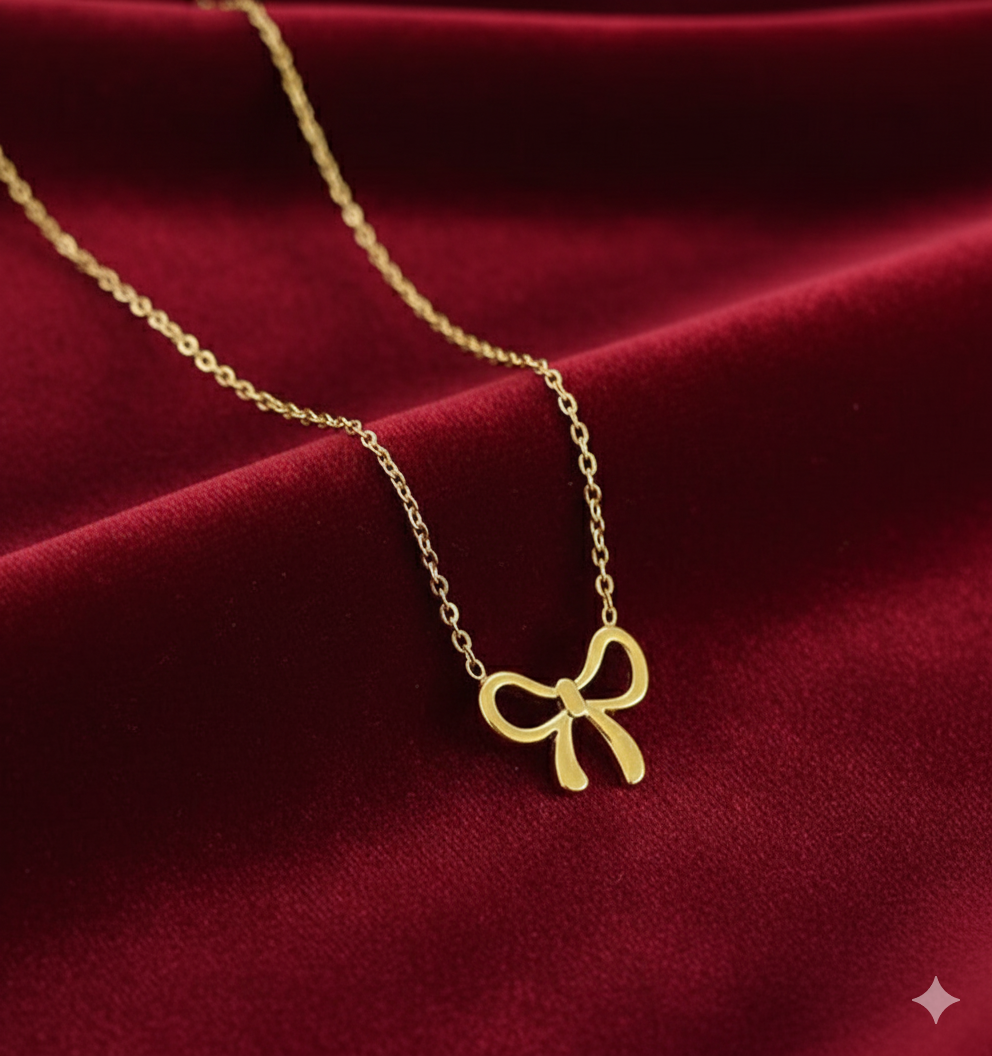 Elegant Gold Bow Pendant Necklace - ORYX TREND NecklaceA beautiful and classic necklace featuring a polished gold pendant shaped like a timeless bow. The delicate bow is suspended from a fine, matching gold chain, presented here in its signature blue jewelry box. Perfect for adding a touch of sophisticated charm to any outfit or as a thoughtful gift.Default Title#