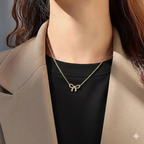 Elegant Gold Bow Pendant Necklace - ORYX TREND NecklaceA beautiful and classic necklace featuring a polished gold pendant shaped like a timeless bow. The delicate bow is suspended from a fine, matching gold chain, presented here in its signature blue jewelry box. Perfect for adding a touch of sophisticated charm to any outfit or as a thoughtful gift.Default Title#