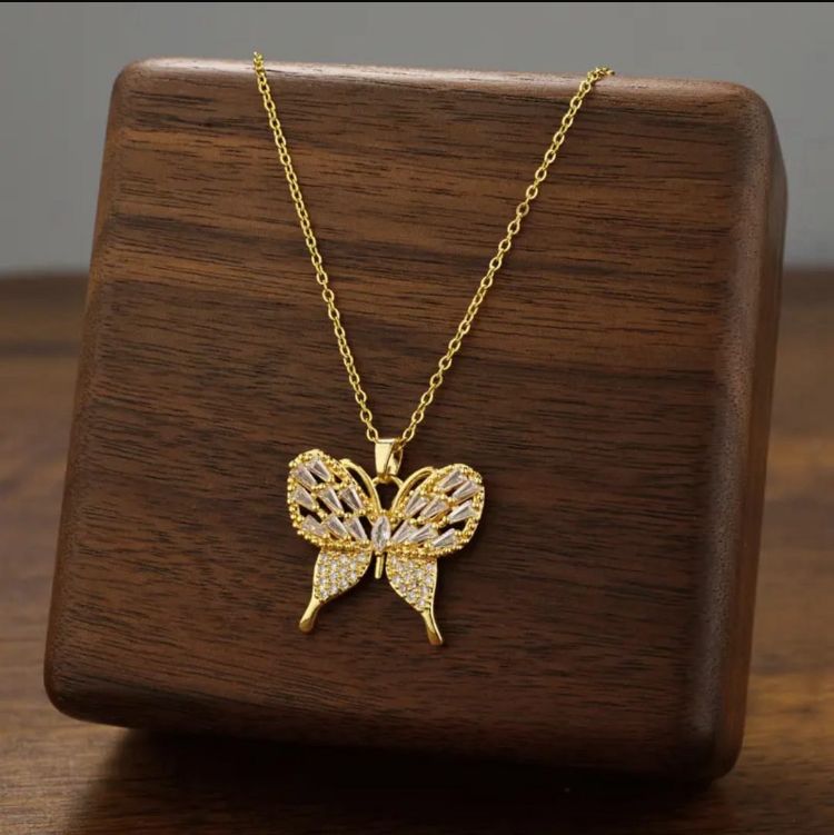 Dazzling Gold Butterfly Necklace - ORYX TREND NecklaceElevate your style with this exquisite gold-plated butterfly necklace. Featuring a beautifully crafted butterfly pendant adorned with sparkling cubic zirconia (CZ) stones, this piece captures the essence of elegance and freedom. The delicate design and brilliant shine make it a perfect accessory for both everyday wear and special occasions.Default Title#