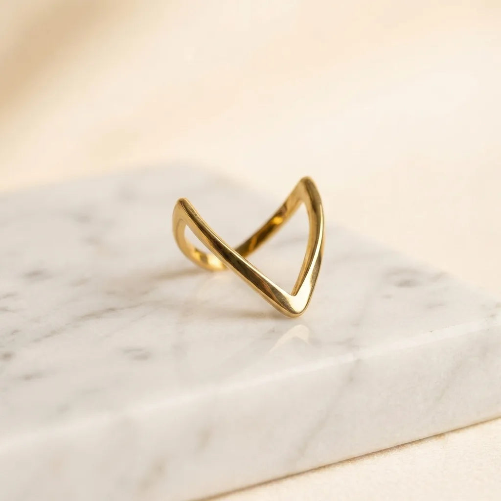 Gold Chevron V-Shape Ring - Minimalist Stacking Jewelry - ORYX TREND RingDiscover the sleek elegance of the ORYX trend Gold Chevron V-Shape Ring. Its sharp, geometric line and highly polished finish make it the definition of modern minimalist jewelry. Perfect for wearing solo for a subtle statement or as a stacking ring to complement an engagement ring or other bands. A versatile and essential piece of contemporary gold jewelry for the modern trendsetter. Shop ORYX trend for simple, chic design.#
