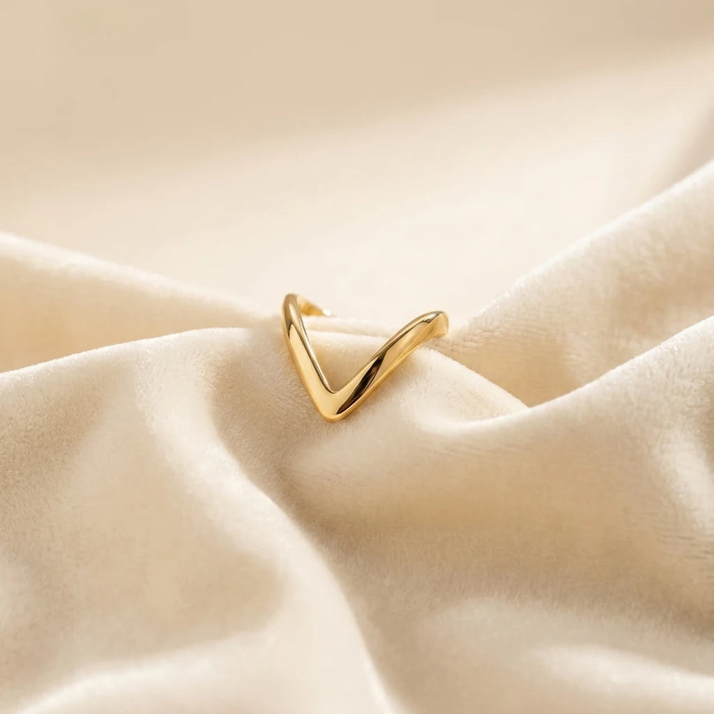 Gold Chevron V-Shape Ring - Minimalist Stacking Jewelry - ORYX TREND RingDiscover the sleek elegance of the ORYX trend Gold Chevron V-Shape Ring. Its sharp, geometric line and highly polished finish make it the definition of modern minimalist jewelry. Perfect for wearing solo for a subtle statement or as a stacking ring to complement an engagement ring or other bands. A versatile and essential piece of contemporary gold jewelry for the modern trendsetter. Shop ORYX trend for simple, chic design.#