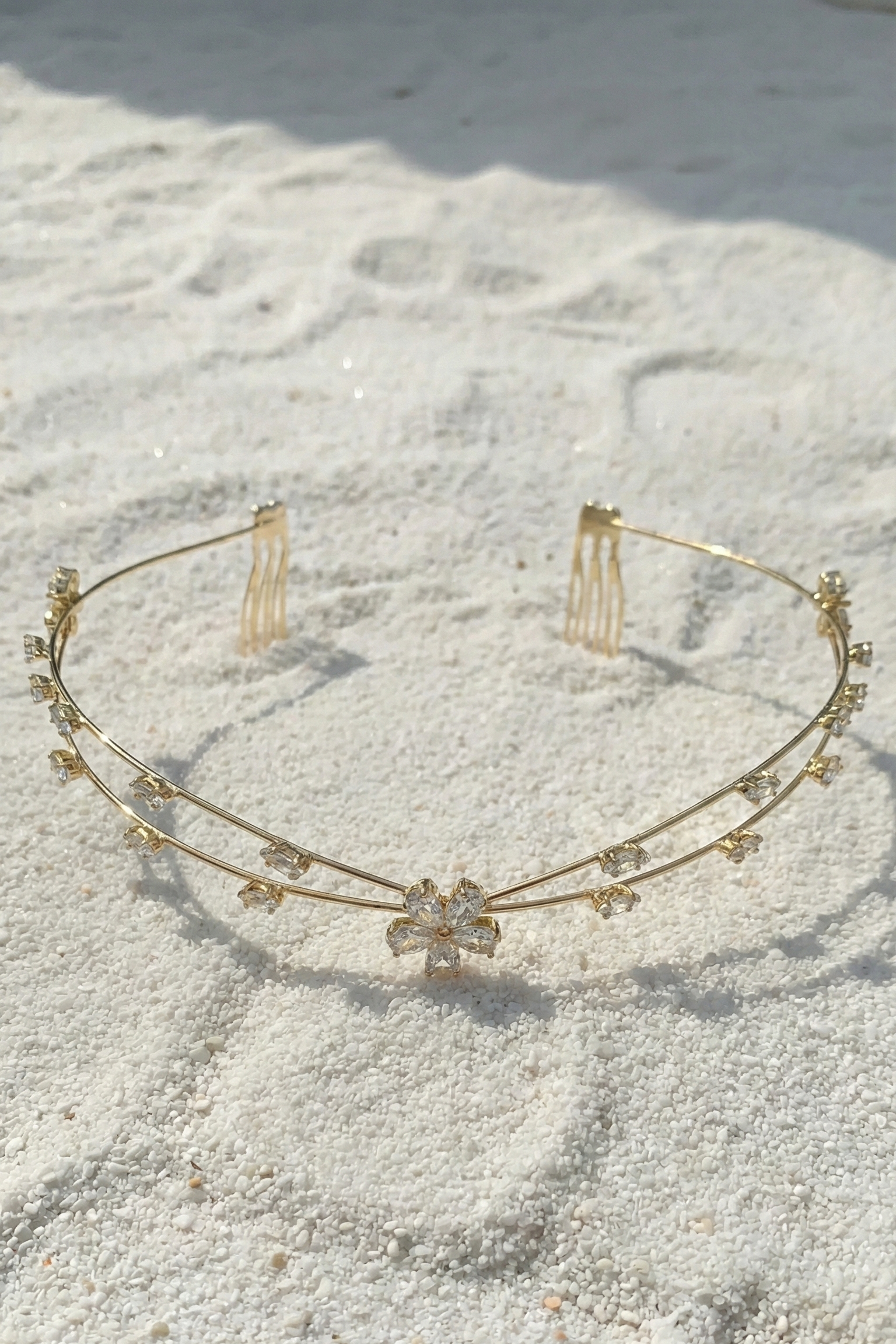 Gold headband with small decorative elements on a textured surface