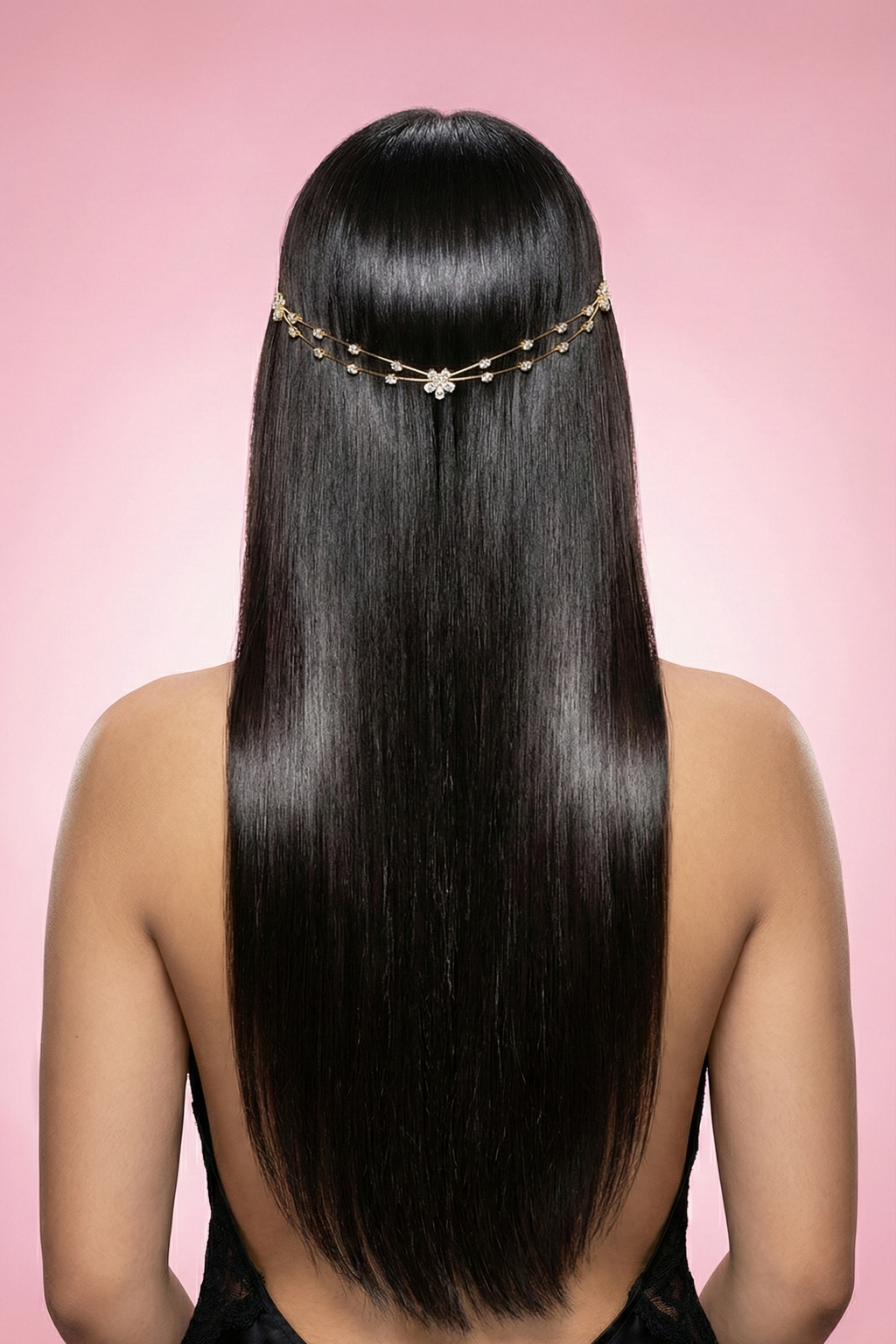 Woman with long straight hair wearing a decorative headband against a pink background