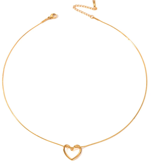 Gold necklace with a heart-shaped pendant on a white background