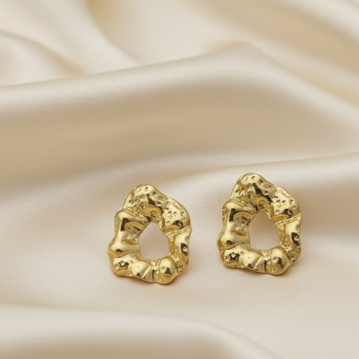 Statement Gold-Tone Molten Nugget Stainless Steel Earrings - ORYX TREND EaringA pair of bold and contemporary earrings featuring a distinctive, organic, "molten" texture. The abstract, irregular shape and hammered-look finish give them a high-fashion, artisanal appeal. Crafted from durable stainless steel and finished in a bright gold tone, these earrings are designed to be long-lasting and make a powerful statement. Perfect for adding a modern, sculptural touch to any outfit.Default Title#