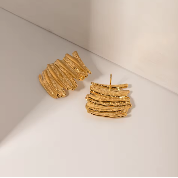 Gold Sculptural Statement Earrings - ORYX TREND EaringThese bold, gold statement earrings feature a unique, sculptural design with a striking, textured surface. Their rectangular shape and uneven, layered finish create a modern, abstract look that catches the light beautifully. Perfect for adding a touch of artistic flair to any outfit, these chunky gold earrings are a versatile accessory for both everyday wear and special occasions.Default Title#