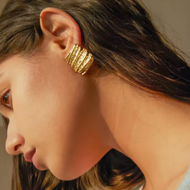 Gold Sculptural Statement Earrings - ORYX TREND EaringThese bold, gold statement earrings feature a unique, sculptural design with a striking, textured surface. Their rectangular shape and uneven, layered finish create a modern, abstract look that catches the light beautifully. Perfect for adding a touch of artistic flair to any outfit, these chunky gold earrings are a versatile accessory for both everyday wear and special occasions.Default Title#
