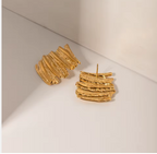 Gold Sculptural Statement Earrings - ORYX TREND EaringThese bold, gold statement earrings feature a unique, sculptural design with a striking, textured surface. Their rectangular shape and uneven, layered finish create a modern, abstract look that catches the light beautifully. Perfect for adding a touch of artistic flair to any outfit, these chunky gold earrings are a versatile accessory for both everyday wear and special occasions.Default Title#