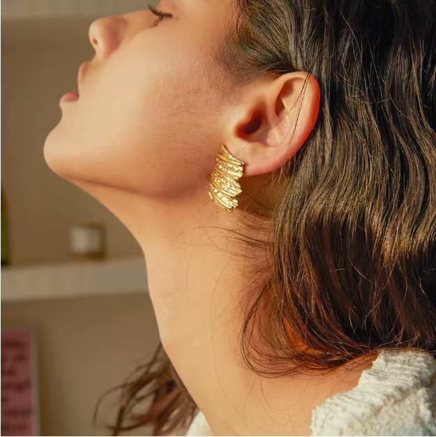 Gold Sculptural Statement Earrings - ORYX TREND EaringThese bold, gold statement earrings feature a unique, sculptural design with a striking, textured surface. Their rectangular shape and uneven, layered finish create a modern, abstract look that catches the light beautifully. Perfect for adding a touch of artistic flair to any outfit, these chunky gold earrings are a versatile accessory for both everyday wear and special occasions.Default Title#