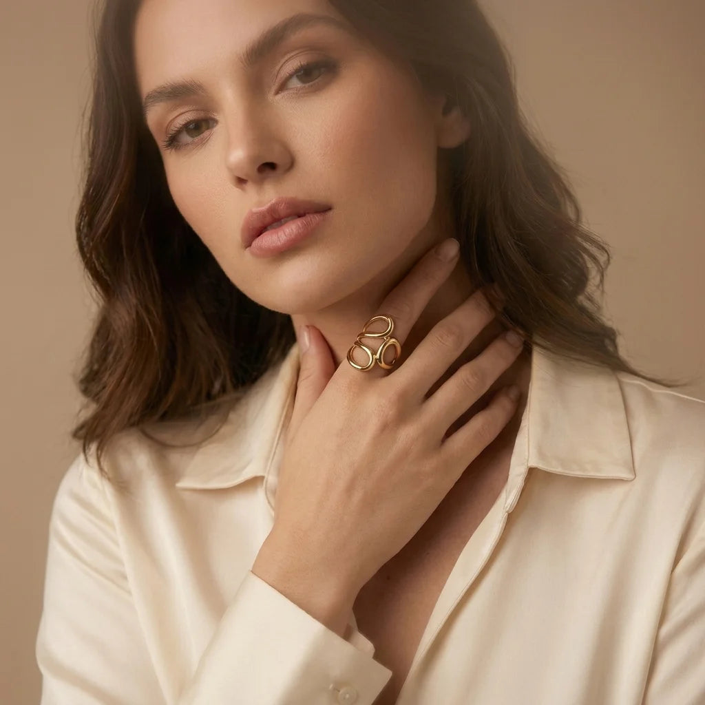 Gold Statement Knot Ring - Modern Minimalist Jewelry - ORYX TREND RingElevate your style with the ORYX trend Gold Statement Knot Ring. This piece features a captivating modern, abstract loop design that makes a bold yet elegant statement. Crafted with high-quality, polished gold-tone metal, this adjustable ring is perfect for the minimalist fashion enthusiast looking for an eye-catching accessory. Ideal for stacking or wearing solo. Shop the best in contemporary gold Plated jewelry from ORYX trend.#