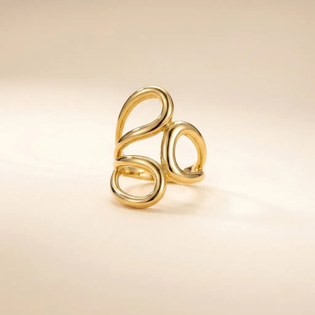 Gold Statement Knot Ring - Modern Minimalist Jewelry - ORYX TREND RingElevate your style with the ORYX trend Gold Statement Knot Ring. This piece features a captivating modern, abstract loop design that makes a bold yet elegant statement. Crafted with high-quality, polished gold-tone metal, this adjustable ring is perfect for the minimalist fashion enthusiast looking for an eye-catching accessory. Ideal for stacking or wearing solo. Shop the best in contemporary gold Plated jewelry from ORYX trend.#