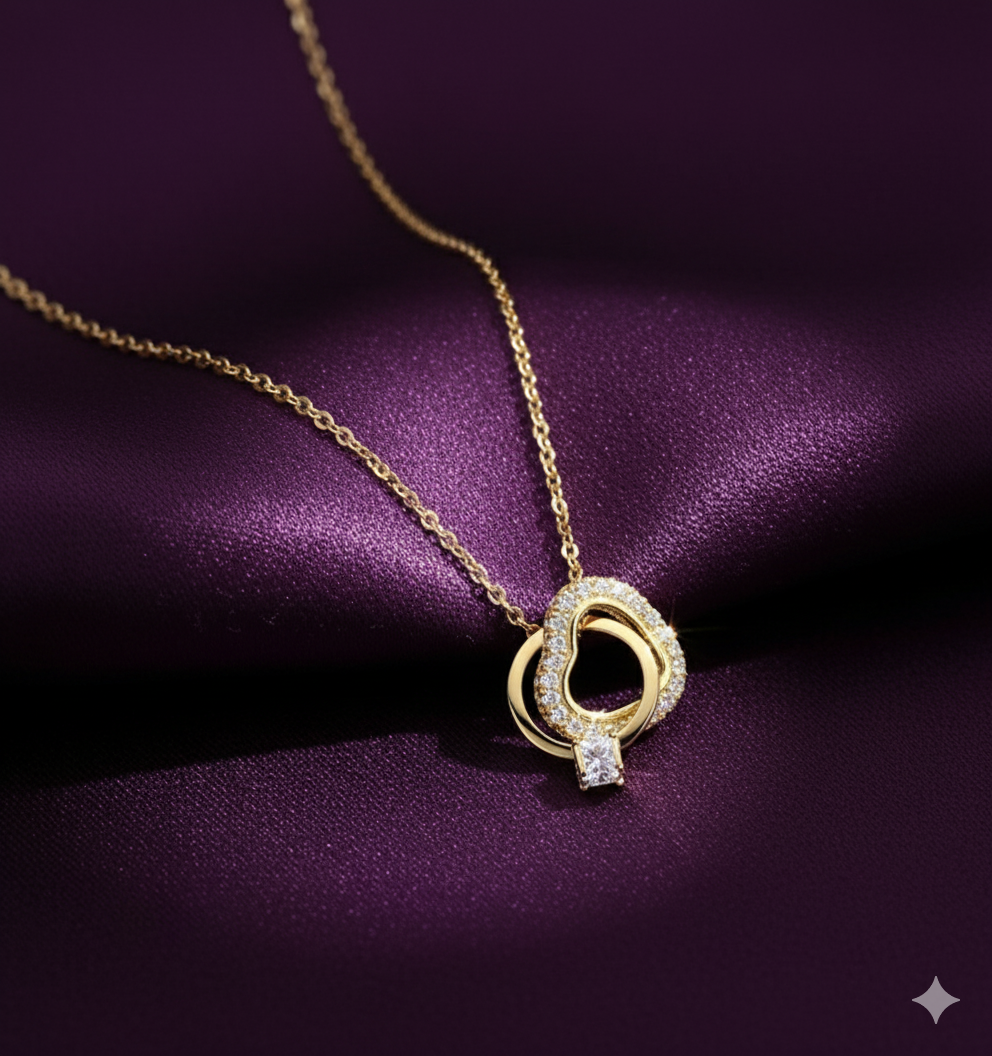 Interlocking Hearts Gold-Tone Necklace with Crystal Pavé - ORYX TREND NecklaceA delicate and sentimental necklace featuring two beautifully interlocking rings. One ring is a heart shape completely adorned with sparkling crystal pavé stones, while the other is a smooth, polished ring. This design symbolizes infinite love and unbreakable connection. The pendant is suspended from a fine, gold-tone chain, making it an ideal gift for an anniversary, Valentine's Day, or just to show someone you careDefault Title#