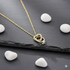 Interlocking Hearts Gold-Tone Necklace with Crystal Pavé - ORYX TREND NecklaceA delicate and sentimental necklace featuring two beautifully interlocking rings. One ring is a heart shape completely adorned with sparkling crystal pavé stones, while the other is a smooth, polished ring. This design symbolizes infinite love and unbreakable connection. The pendant is suspended from a fine, gold-tone chain, making it an ideal gift for an anniversary, Valentine's Day, or just to show someone you careDefault Title#