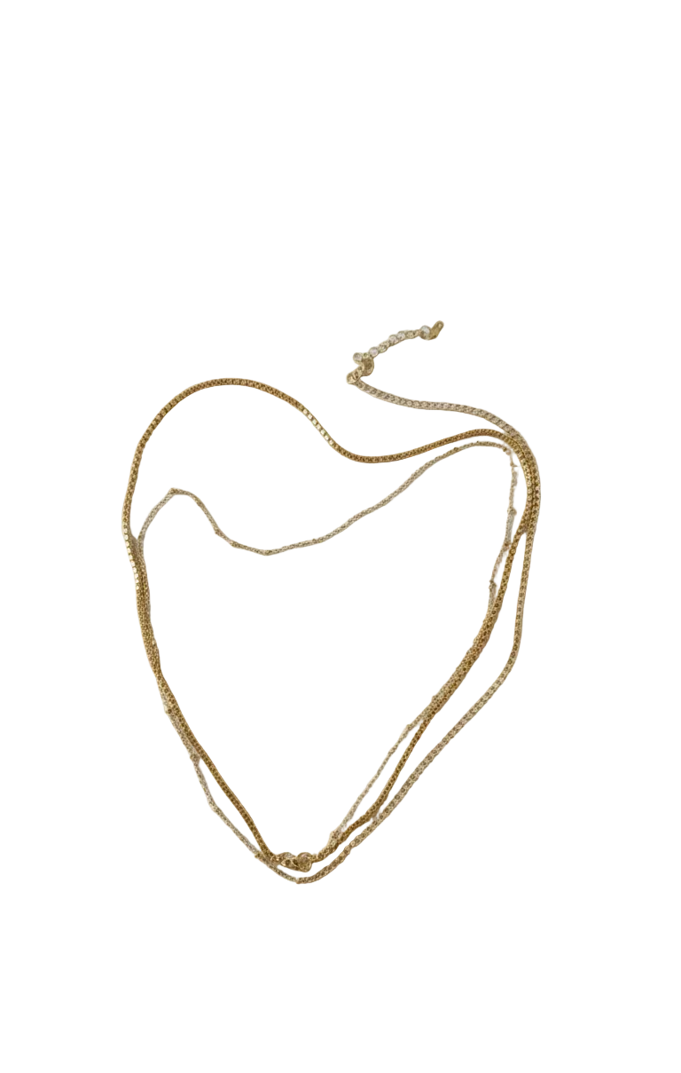 Gold necklace on a white fabric background