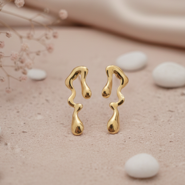 Melted Gold Drip Stud Earrings - ORYX TREND EaringMake a modern statement with these captivating Melted Gold Drip Stud Earrings. Featuring a popular liquid metal or abstract design, these studs mimic the look of dripping gold, offering a unique, sculptural touch to any ensemble. Perfect for the fashion-forward individual seeking edgy, contemporary jewelry. Lightweight and polished for high shine. Style: Abstract, Liquid Metal, Drip, ModernDefault Title#