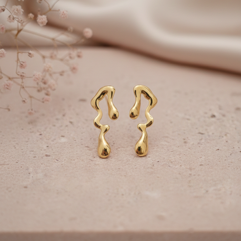Melted Gold Drip Stud Earrings - ORYX TREND EaringMake a modern statement with these captivating Melted Gold Drip Stud Earrings. Featuring a popular liquid metal or abstract design, these studs mimic the look of dripping gold, offering a unique, sculptural touch to any ensemble. Perfect for the fashion-forward individual seeking edgy, contemporary jewelry. Lightweight and polished for high shine. Style: Abstract, Liquid Metal, Drip, ModernDefault Title#