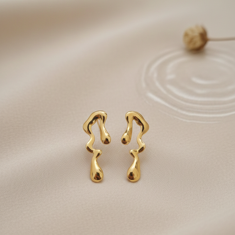 Melted Gold Drip Stud Earrings - ORYX TREND EaringMake a modern statement with these captivating Melted Gold Drip Stud Earrings. Featuring a popular liquid metal or abstract design, these studs mimic the look of dripping gold, offering a unique, sculptural touch to any ensemble. Perfect for the fashion-forward individual seeking edgy, contemporary jewelry. Lightweight and polished for high shine. Style: Abstract, Liquid Metal, Drip, ModernDefault Title#