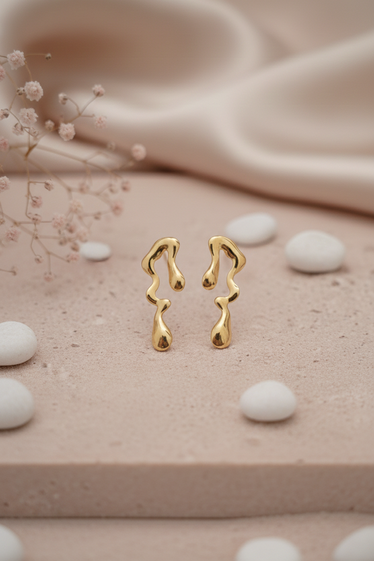 Melted Gold Drip Stud Earrings - ORYX TREND EaringMake a modern statement with these captivating Melted Gold Drip Stud Earrings. Featuring a popular liquid metal or abstract design, these studs mimic the look of dripping gold, offering a unique, sculptural touch to any ensemble. Perfect for the fashion-forward individual seeking edgy, contemporary jewelry. Lightweight and polished for high shine. Style: Abstract, Liquid Metal, Drip, ModernDefault Title#