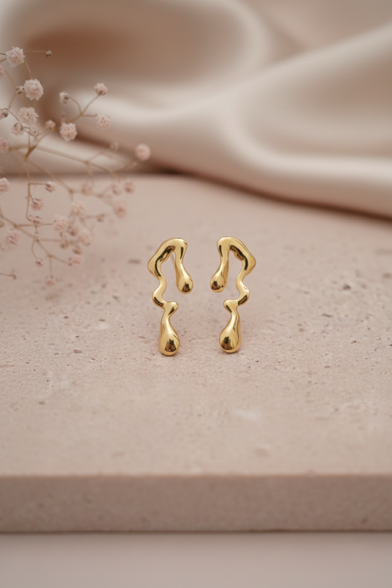 Melted Gold Drip Stud Earrings - ORYX TREND EaringMake a modern statement with these captivating Melted Gold Drip Stud Earrings. Featuring a popular liquid metal or abstract design, these studs mimic the look of dripping gold, offering a unique, sculptural touch to any ensemble. Perfect for the fashion-forward individual seeking edgy, contemporary jewelry. Lightweight and polished for high shine. Style: Abstract, Liquid Metal, Drip, ModernDefault Title#