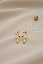 Melted Gold Drip Stud Earrings - ORYX TREND EaringMake a modern statement with these captivating Melted Gold Drip Stud Earrings. Featuring a popular liquid metal or abstract design, these studs mimic the look of dripping gold, offering a unique, sculptural touch to any ensemble. Perfect for the fashion-forward individual seeking edgy, contemporary jewelry. Lightweight and polished for high shine. Style: Abstract, Liquid Metal, Drip, ModernDefault Title#