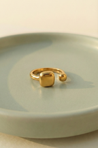 Modern Gold Open Signet Ring - Minimalist Cushion Design - ORYX TREND RingIntroduce effortless style with the ORYX trend Modern Gold Open Signet Ring. This piece updates the classic signet style with a smooth, cushioned square top and a chic, adjustable open band. Perfect for those who appreciate minimalist aesthetics with a bold touch. Its contemporary design makes it ideal for everyday wear or stacking with simple bands. Shop the latest in ORYX trend's modern gold jewelry collection.Default Title#