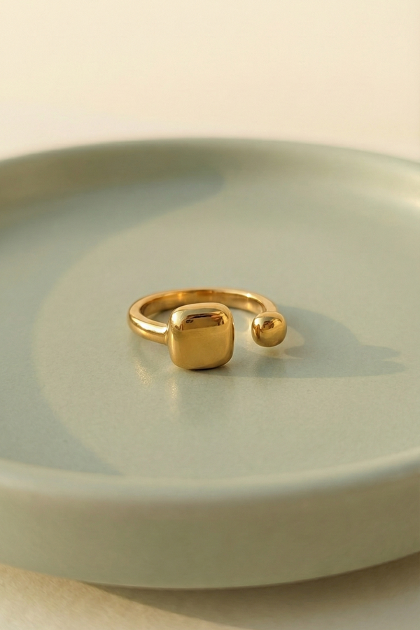 Modern Gold Open Signet Ring - Minimalist Cushion Design - ORYX TREND RingIntroduce effortless style with the ORYX trend Modern Gold Open Signet Ring. This piece updates the classic signet style with a smooth, cushioned square top and a chic, adjustable open band. Perfect for those who appreciate minimalist aesthetics with a bold touch. Its contemporary design makes it ideal for everyday wear or stacking with simple bands. Shop the latest in ORYX trend's modern gold jewelry collection.Default Title#