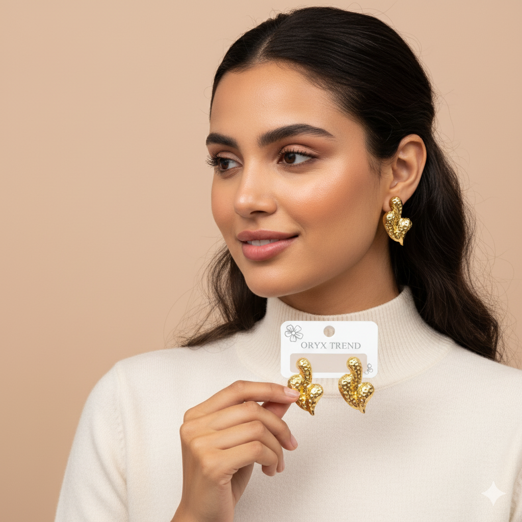 Modern Gold-Tone Hammered Heart Stainless Steel Stud Earrings - ORYX TREND EaringA unique twist on a classic motif, these stud earrings feature a puffy heart shape with a contemporary hammered or "molten" surface texture. Crafted from durable, non-tarnishing stainless steel and finished in a rich gold tone, they offer a chunky, statement look that is still subtle enough for daily wear. The textured finish beautifully catches the light, adding dimension and flair.Default Title#