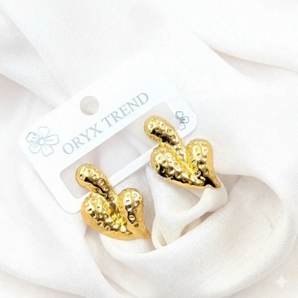 Modern Gold-Tone Hammered Heart Stainless Steel Stud Earrings - ORYX TREND EaringA unique twist on a classic motif, these stud earrings feature a puffy heart shape with a contemporary hammered or "molten" surface texture. Crafted from durable, non-tarnishing stainless steel and finished in a rich gold tone, they offer a chunky, statement look that is still subtle enough for daily wear. The textured finish beautifully catches the light, adding dimension and flair.Default Title#