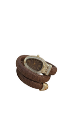 Brown braided leather bracelet with decorative clasp on a white background
