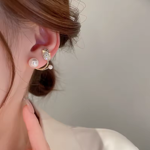 Tulip and Pearl Ear Jacket Studs - ORYX TREND EaringUnique ear jackets featuring a pave crystal tulip/flower stud with a curved gold bar that sits behind the lobe, tipped with graduated faux pearls.Default Title#