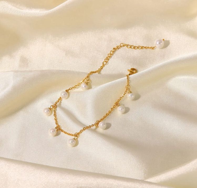Dainty Pearl and Gold Anklet - ORYX TREND AnkletThis charming gold chain anklet is adorned with delicate, evenly spaced pearl beads, creating a classic and elegant look. The dainty design is perfect for adding a touch of sophistication to your summer style. With its adjustable chain, this pearl anklet offers a comfortable fit for any ankle, making it an ideal accessory for both casual and dressy occasions.Default Title#
