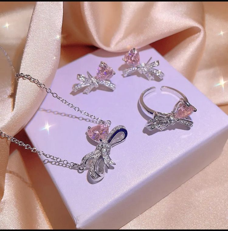 Silver-Plated Cubic Zirconia Bow and Heart Necklace and Earring Set - ORYX TREND NecklaceElevate your style with our charming pink heart and bow jewelry set. This beautiful necklace and earring set is adorned with sparkling rhinestones and a cubic zirconia heart, making it an ideal accessory for any outfit. It's a perfect gift for someone special.Default Title#