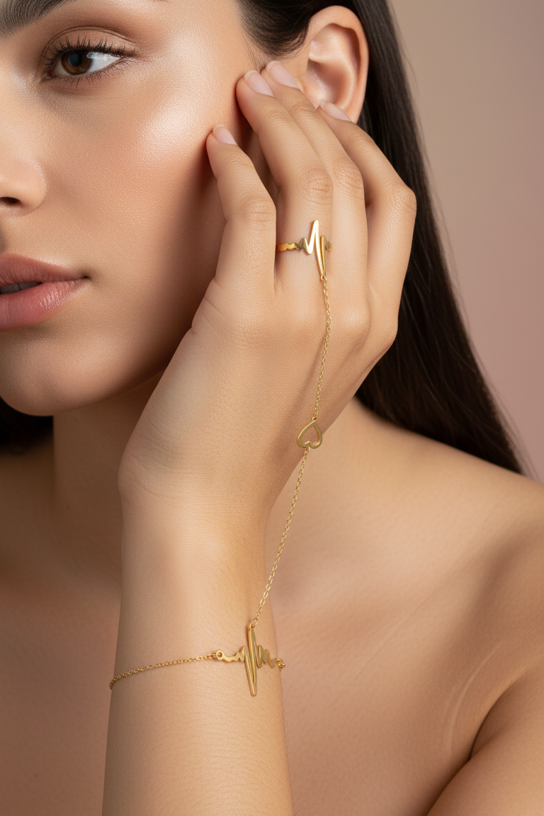 Woman wearing gold jewelry on a neutral background